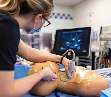 Nursing student using a sonogram wand in the simulation lab